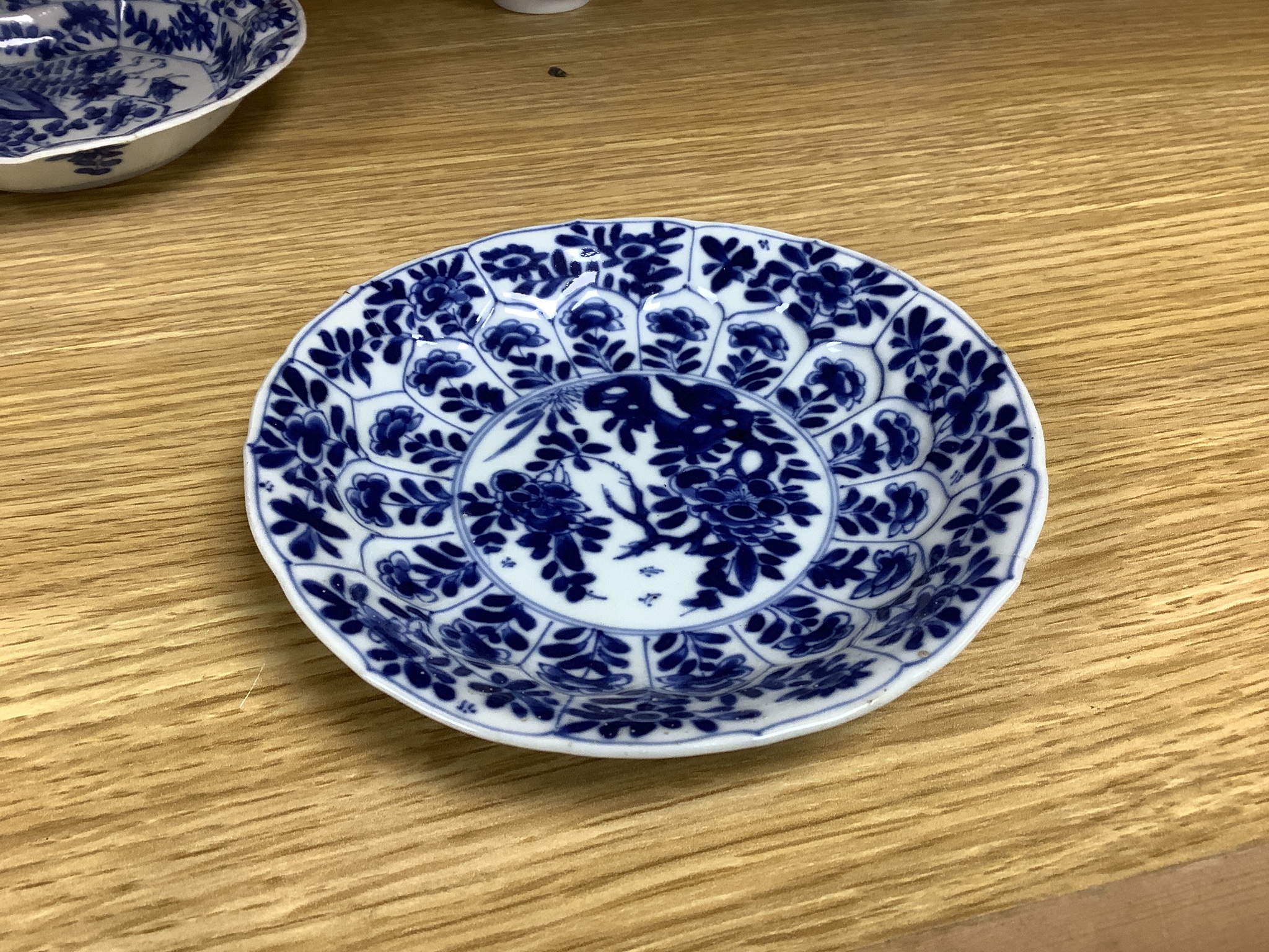 A Chinese blue and white plate 13cm diameter, a similar tea bowl and saucer, Kangxi period and a 19th century Chinese blue and white bottle vase